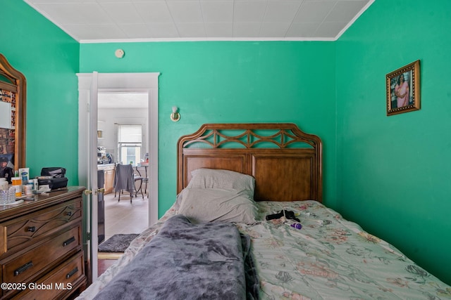 bedroom featuring tile patterned flooring and crown molding