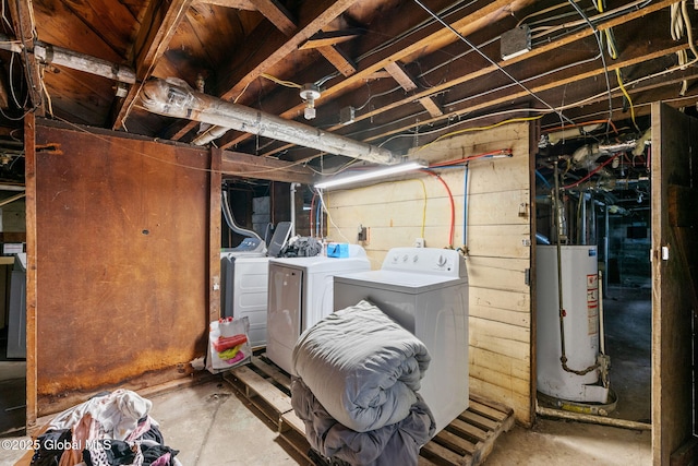 unfinished basement featuring water heater and washing machine and clothes dryer