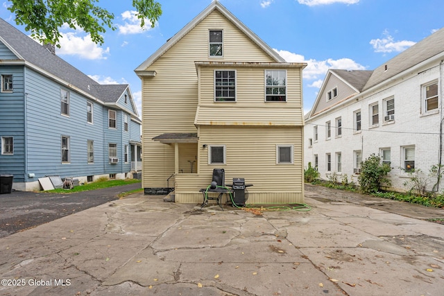 rear view of house featuring a patio