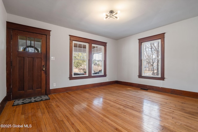 entrance foyer featuring light wood-style flooring, baseboards, and visible vents