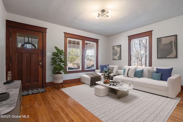 living area with baseboards and light wood-style flooring