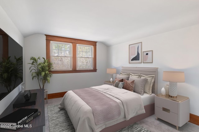 bedroom featuring baseboards and vaulted ceiling