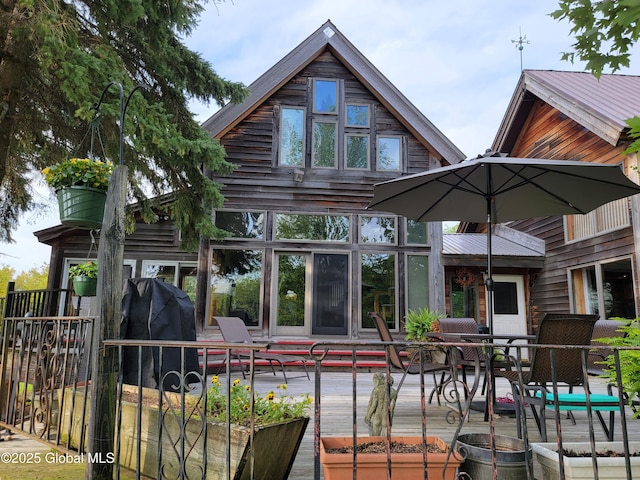 rear view of property featuring a sunroom