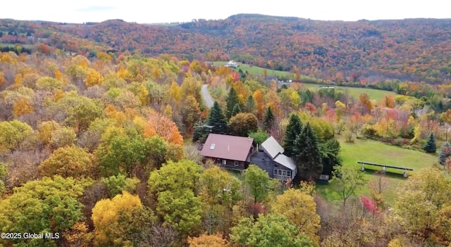 birds eye view of property featuring a view of trees