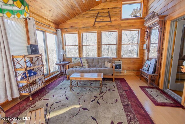 sunroom with plenty of natural light, wood ceiling, vaulted ceiling, and heating unit