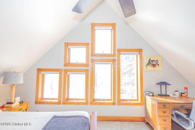 bedroom featuring lofted ceiling and baseboards