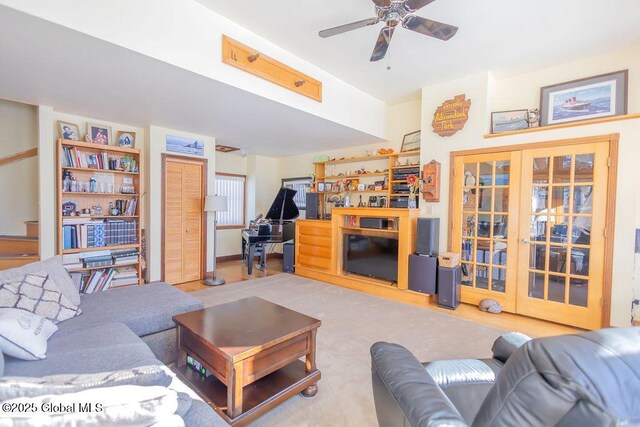 living area featuring a ceiling fan and french doors