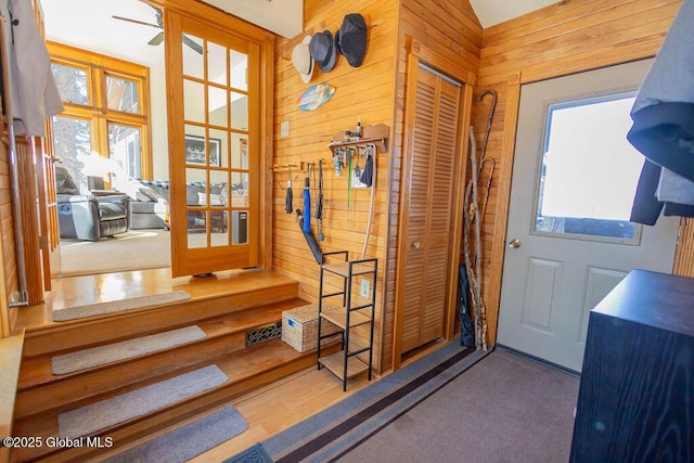 entryway with wooden walls