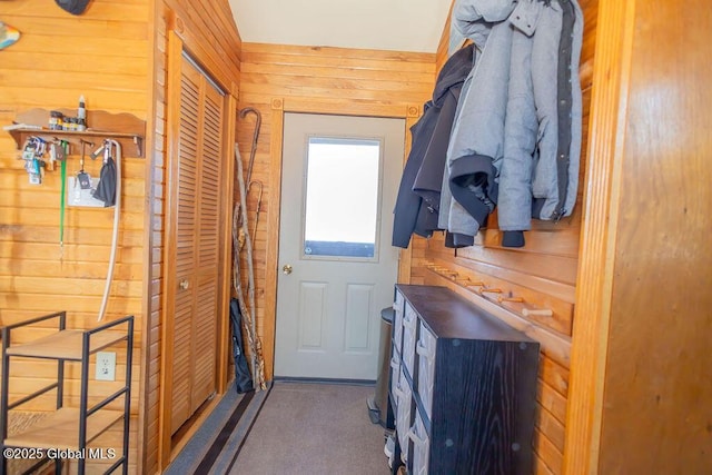 doorway to outside featuring wooden walls