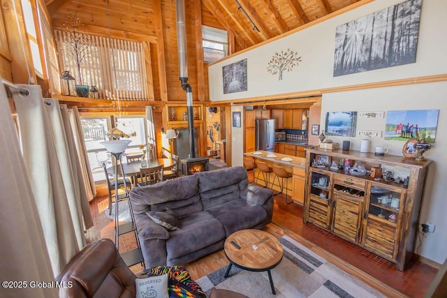 living area featuring high vaulted ceiling, a wealth of natural light, wood ceiling, and wood finished floors