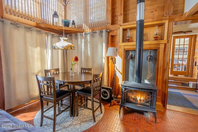 dining room with brick floor and a wood stove