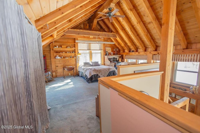 unfurnished bedroom with carpet, wood ceiling, wood walls, and lofted ceiling with beams