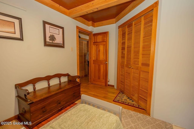 hall featuring beamed ceiling and wood finished floors