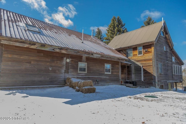 snow covered house with metal roof