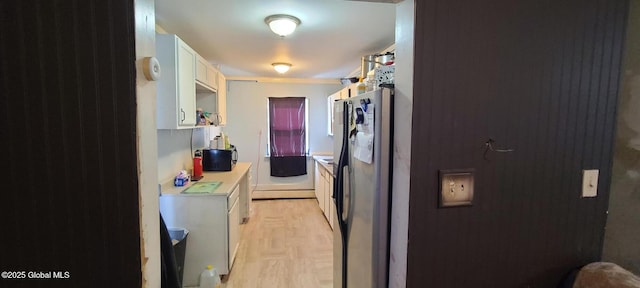 kitchen with white cabinets, light countertops, and stainless steel fridge with ice dispenser