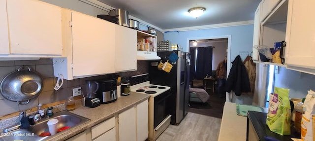 kitchen featuring electric range, decorative backsplash, range hood, white cabinetry, and a sink