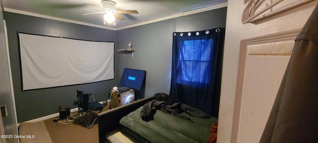 carpeted bedroom with ceiling fan, baseboards, and crown molding