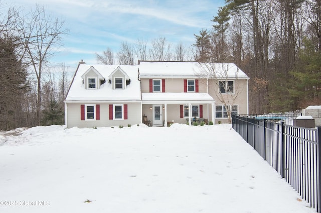 view of front of house featuring a chimney and fence