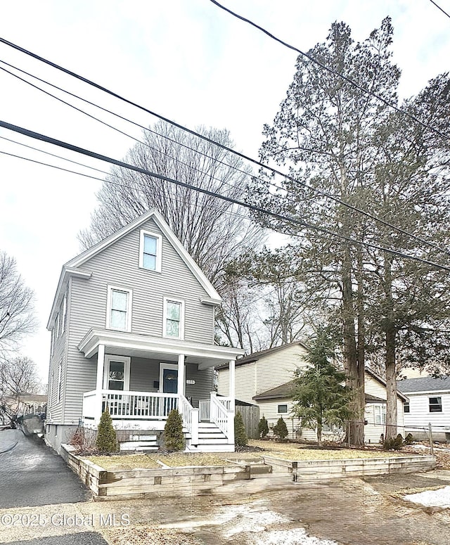 american foursquare style home with covered porch