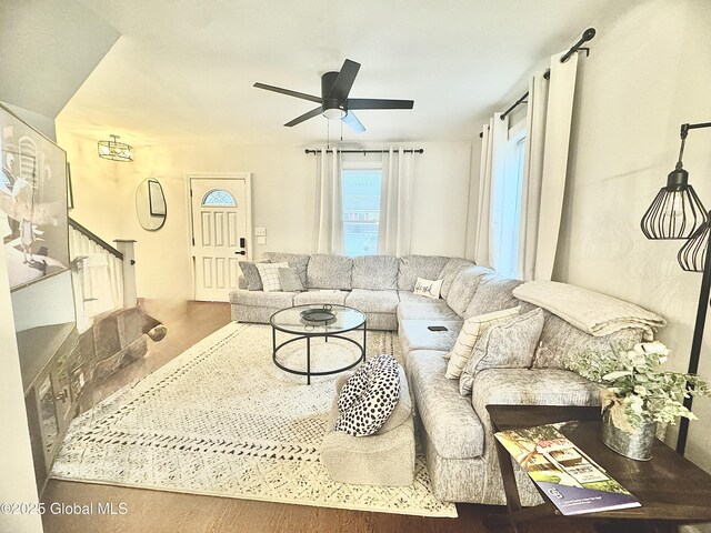 living room featuring stairway and a ceiling fan