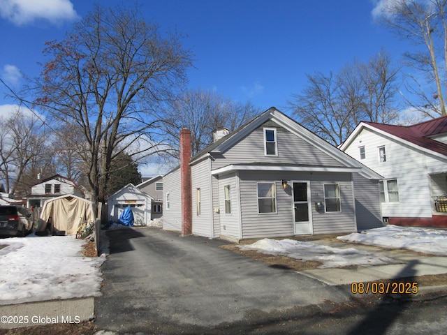 view of front of home with an outbuilding and a chimney