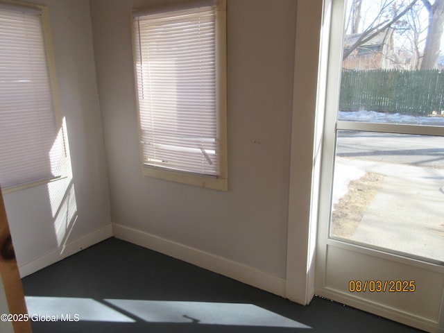 interior space featuring baseboards and a wealth of natural light