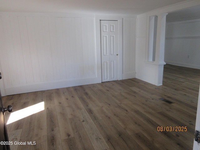 interior space with wood finished floors and visible vents