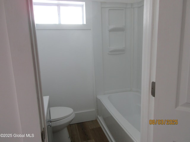 bathroom featuring baseboards, toilet, and wood finished floors