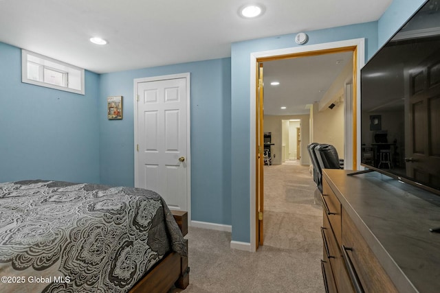 bedroom with recessed lighting, baseboards, and light carpet