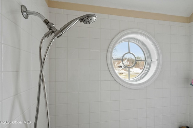 interior details featuring a tile shower