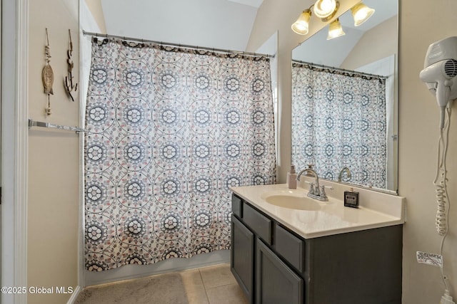 bathroom featuring tile patterned flooring, vanity, and shower / bath combo