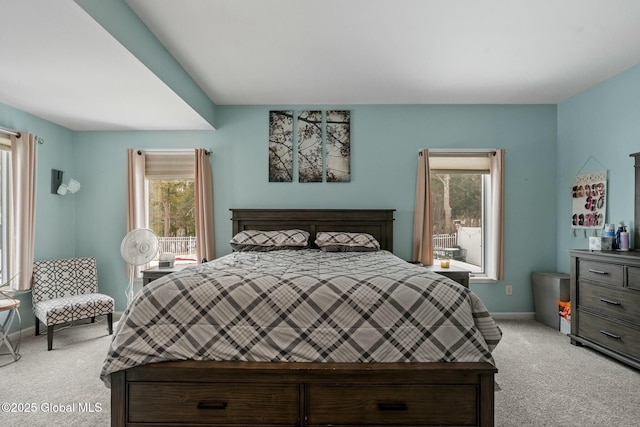 bedroom featuring baseboards and light carpet