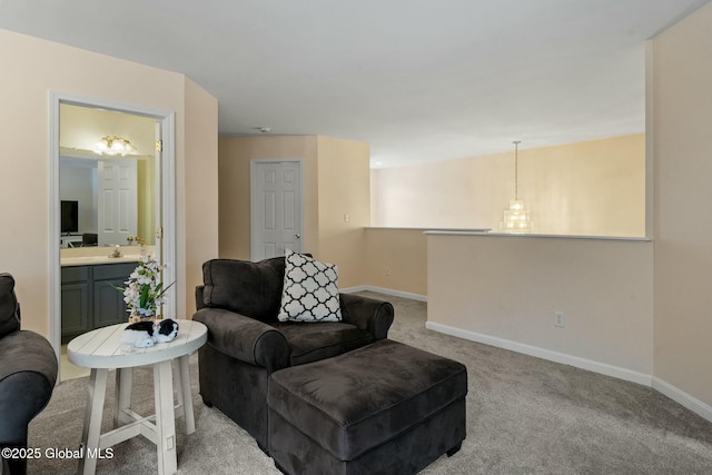 carpeted living room featuring baseboards