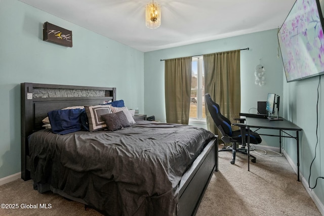 bedroom with baseboards and carpet