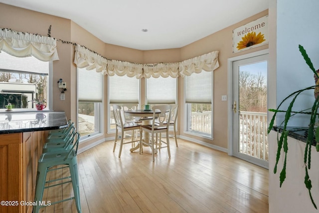 dining area with baseboards and light wood-style floors