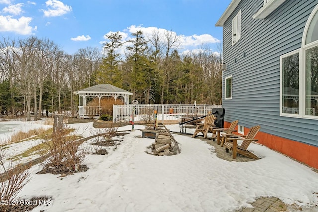 snowy yard featuring a gazebo