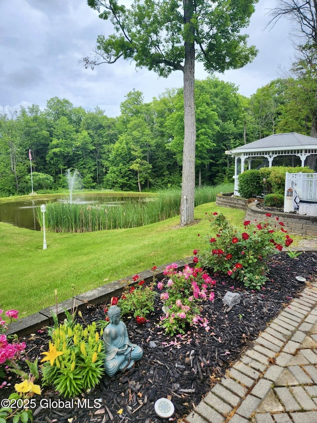 view of yard featuring a gazebo and a view of trees