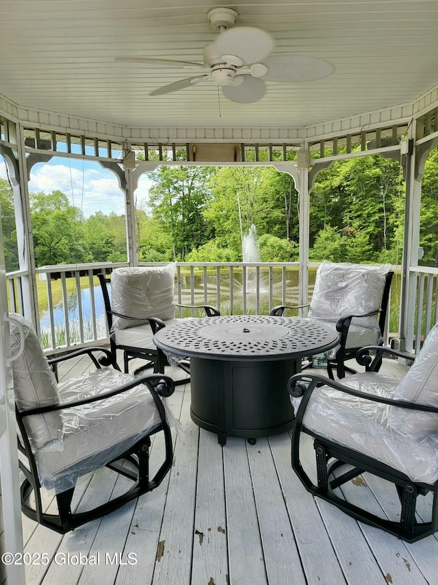 wooden terrace with a ceiling fan