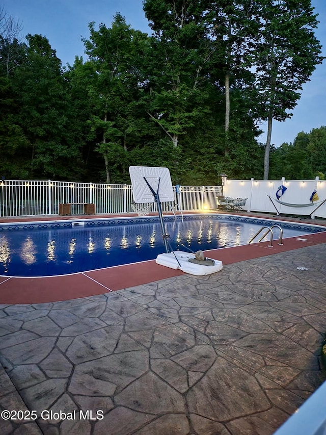 view of swimming pool with a fenced in pool, a patio, and fence