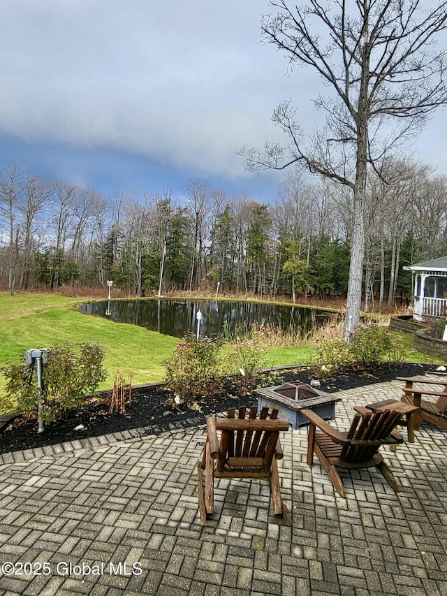 view of patio featuring a water view and an outdoor fire pit