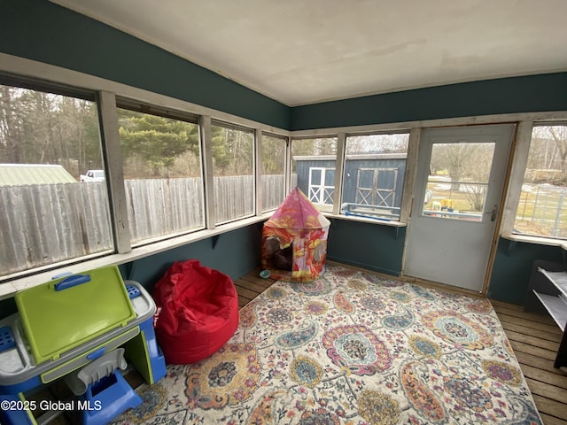 sunroom / solarium featuring a healthy amount of sunlight