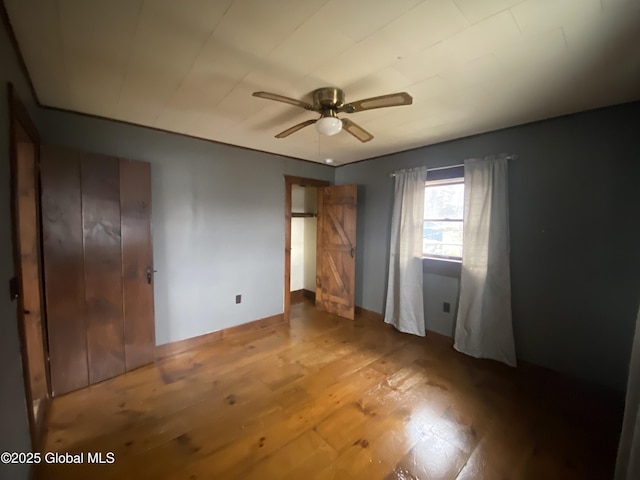 unfurnished bedroom with ceiling fan and hardwood / wood-style flooring