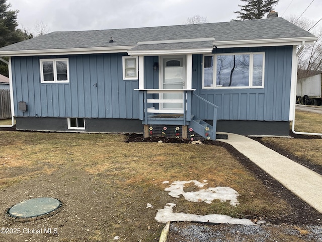 view of front of home featuring board and batten siding and roof with shingles