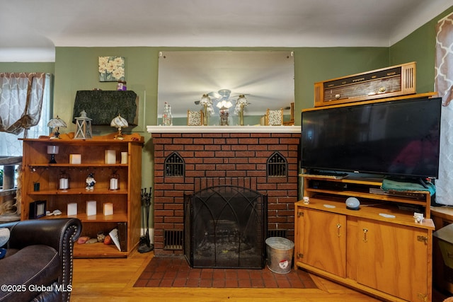 living room with light wood-style flooring and a fireplace