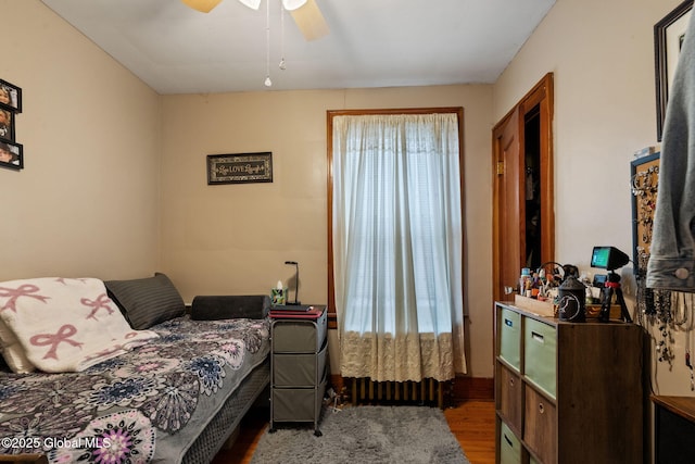 bedroom featuring a ceiling fan and wood finished floors