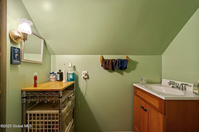 bathroom with vaulted ceiling and vanity