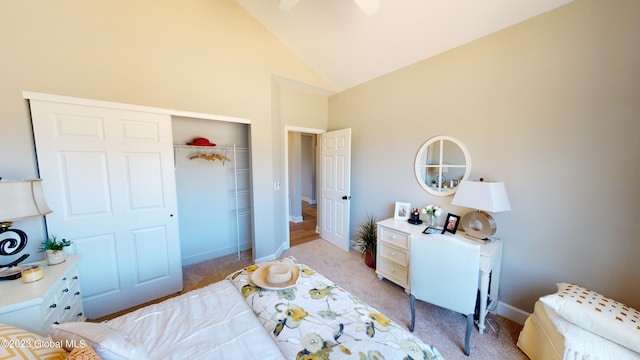 bedroom with a closet, a ceiling fan, light carpet, high vaulted ceiling, and baseboards