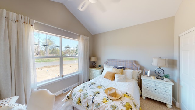 bedroom with ceiling fan, light carpet, visible vents, baseboards, and vaulted ceiling