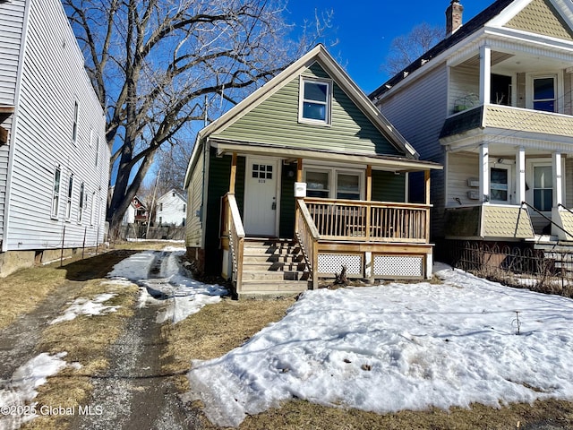 view of front of home with covered porch and a balcony