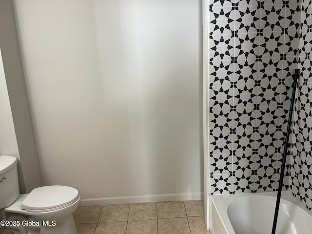 bathroom featuring toilet, shower / bath combination, baseboards, and tile patterned floors